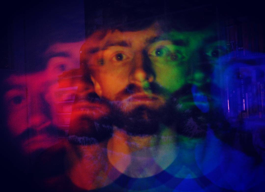 A photograph of Douglas illuminated with a rainbow multiple exposure image.